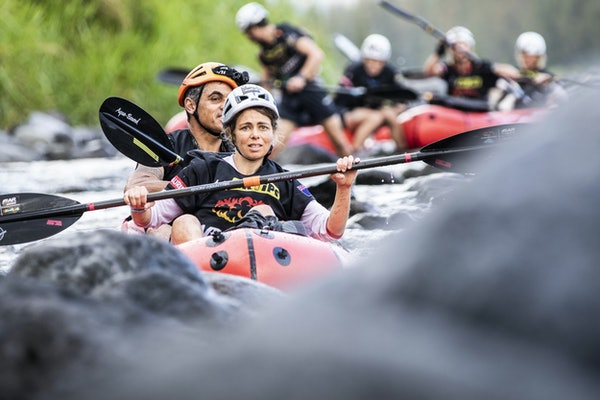 Adventure Racers Kayaking Down a River