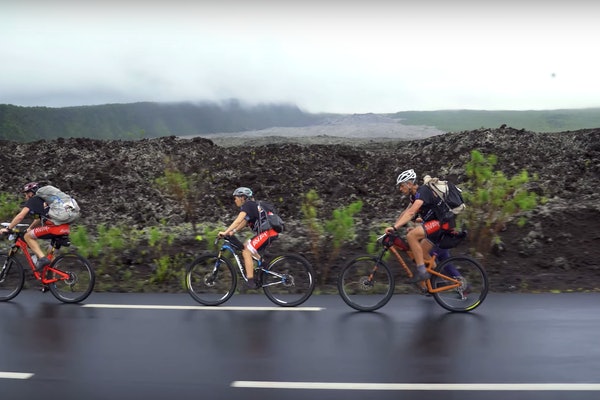 Adventure Racers Biking on a Road